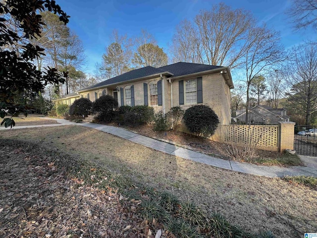 ranch-style home with brick siding and fence