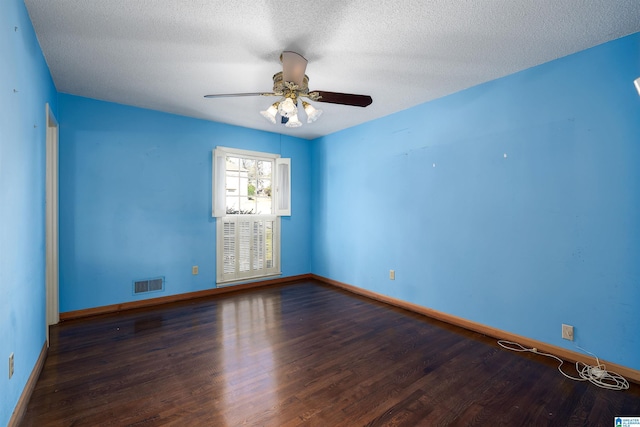 unfurnished room with wood finished floors, baseboards, visible vents, ceiling fan, and a textured ceiling