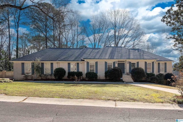 single story home featuring brick siding and a front lawn