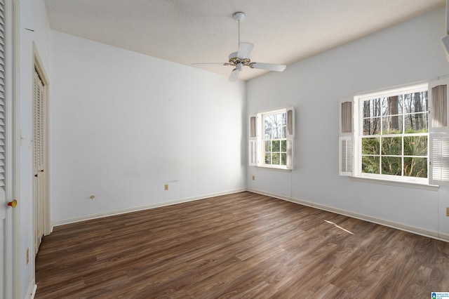 spare room with baseboards, a textured ceiling, a ceiling fan, and wood finished floors