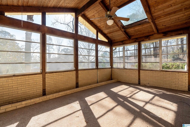 unfurnished sunroom with vaulted ceiling with skylight, wood ceiling, and ceiling fan