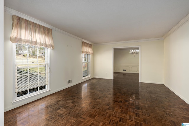 unfurnished room featuring a chandelier, visible vents, baseboards, and ornamental molding