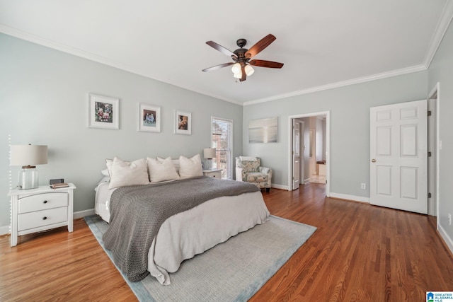 bedroom featuring ornamental molding, baseboards, and wood finished floors