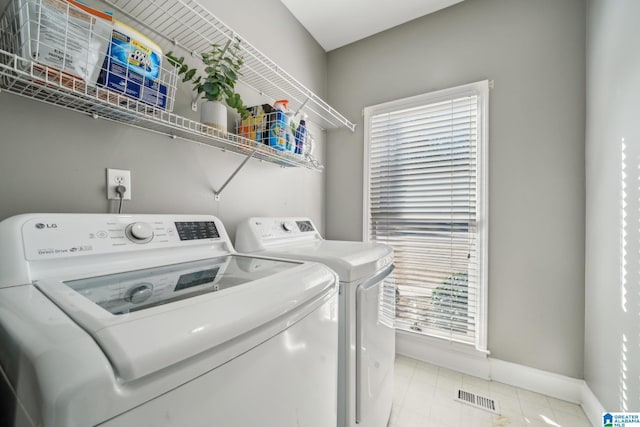 laundry area featuring laundry area, independent washer and dryer, visible vents, and baseboards