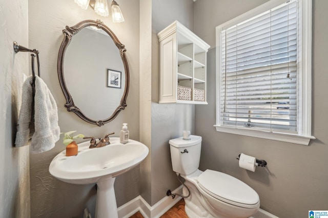 bathroom featuring toilet and baseboards