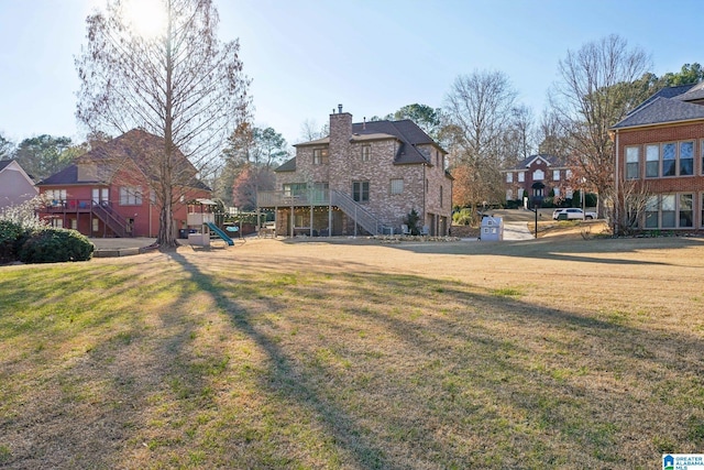 view of yard featuring stairs, a playground, and a residential view