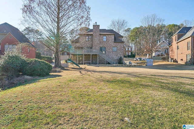 view of yard featuring stairway and a playground