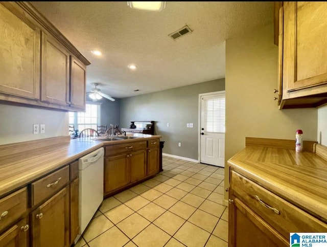 171 Alabaster Dr, Winfield, AL 35594 - kitchen featuring light tile patterned floors, ceiling fan, white dishwasher, a textured ceiling, and a sink