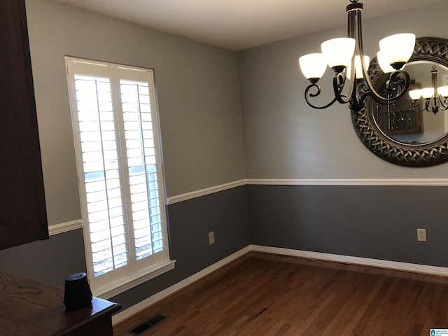 dining space with a notable chandelier, visible vents, baseboards, and dark wood-style flooring