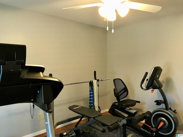 workout area with baseboards and ceiling fan