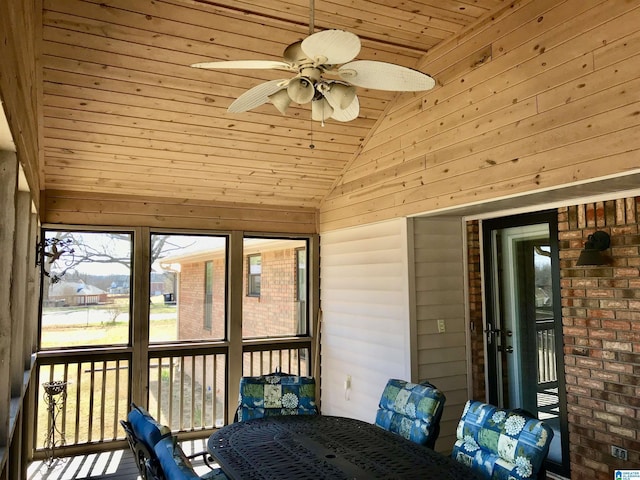 unfurnished sunroom with lofted ceiling, ceiling fan, and wooden ceiling