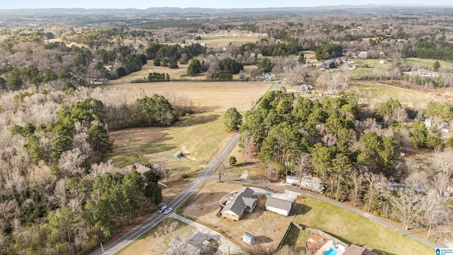 birds eye view of property with a rural view and a wooded view