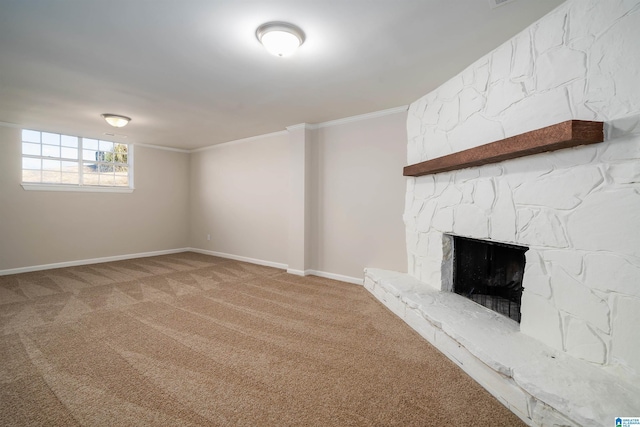 unfurnished living room featuring baseboards, carpet floors, a stone fireplace, and crown molding