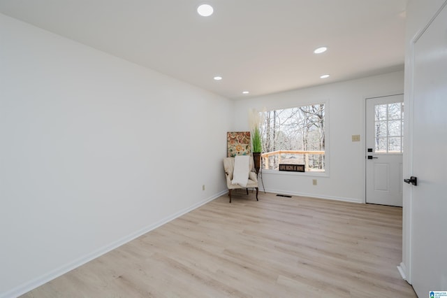 unfurnished room with light wood-style floors, visible vents, baseboards, and recessed lighting