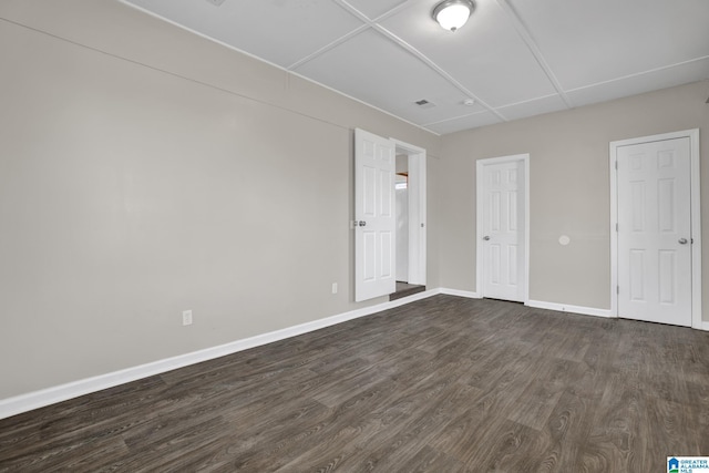 unfurnished bedroom featuring dark wood-style floors and baseboards