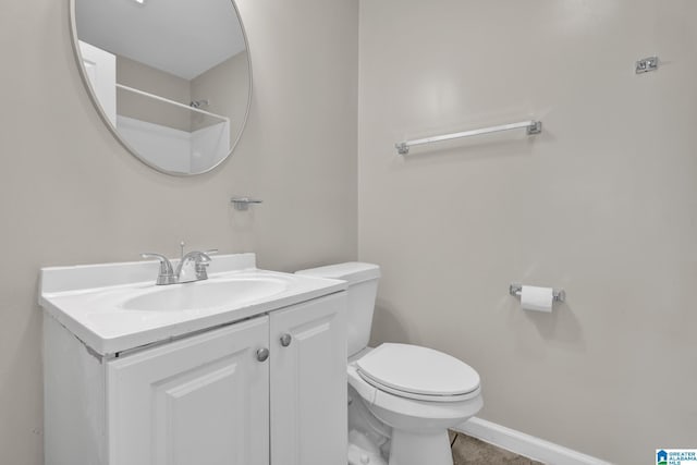 bathroom featuring vanity, toilet, and baseboards