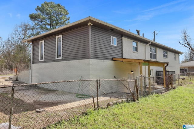 back of property featuring fence and brick siding