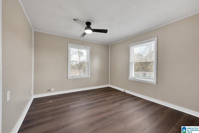 unfurnished room featuring crown molding, dark wood finished floors, a ceiling fan, and baseboards