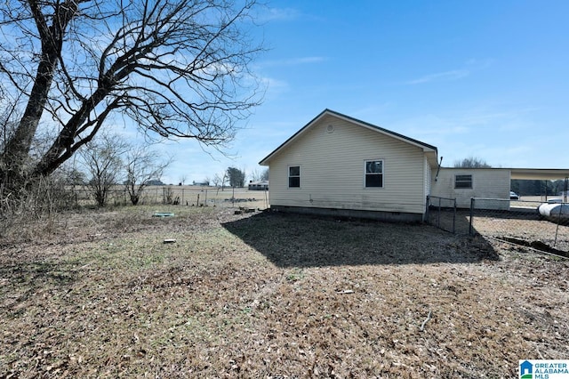 view of side of property featuring crawl space and fence