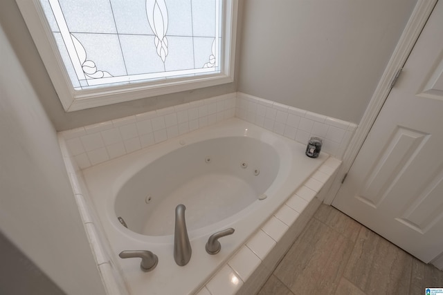 bathroom featuring a tub with jets