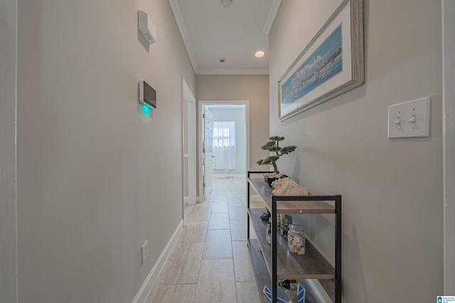 hall with baseboards and ornamental molding