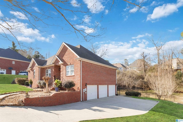 view of side of home featuring an attached garage, brick siding, fence, a yard, and concrete driveway