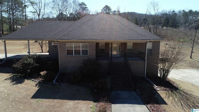 view of front of property with stairs, a porch, and brick siding