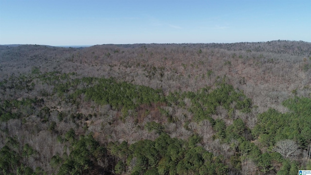 drone / aerial view featuring a wooded view