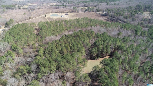 drone / aerial view featuring a forest view