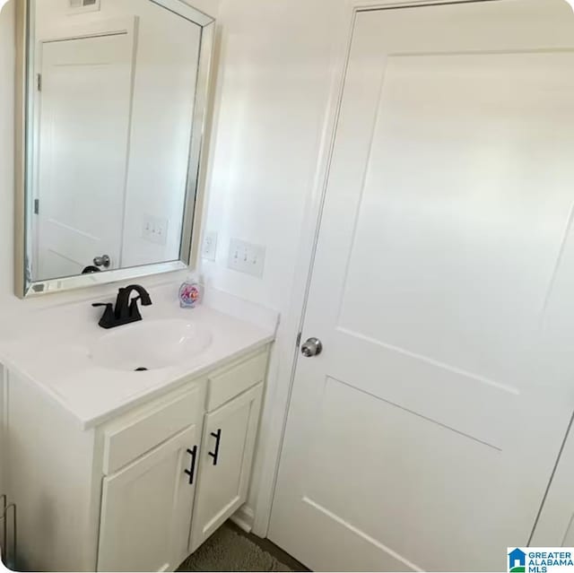 bathroom featuring visible vents and vanity