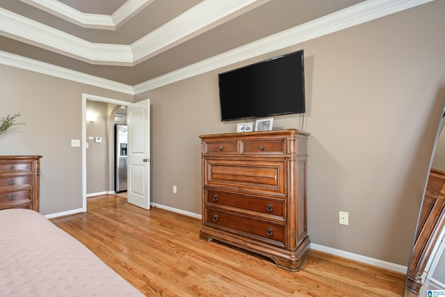 bedroom with ornamental molding, baseboards, stainless steel refrigerator with ice dispenser, and light wood finished floors