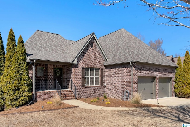 view of front facade featuring a garage, driveway, a shingled roof, and brick siding