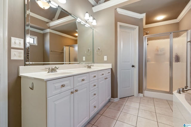 bathroom with double vanity, a stall shower, tile patterned flooring, crown molding, and a sink