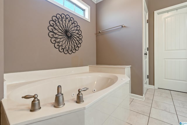 full bathroom featuring a jetted tub, baseboards, and tile patterned floors