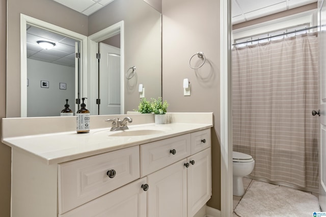 bathroom featuring tile patterned flooring, a shower with curtain, vanity, and toilet