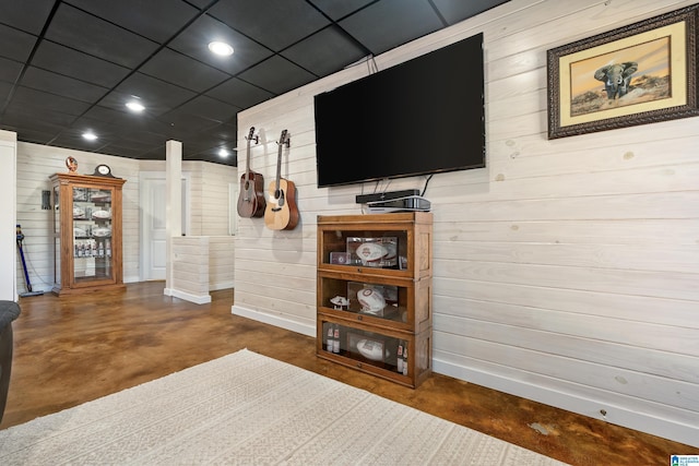 living area with finished concrete floors, baseboards, and recessed lighting