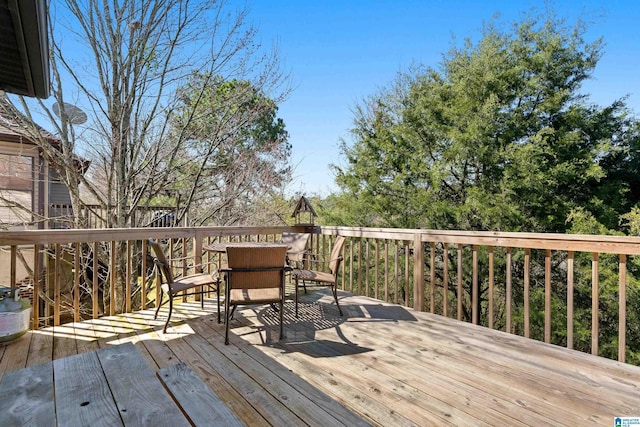 wooden terrace with outdoor dining area