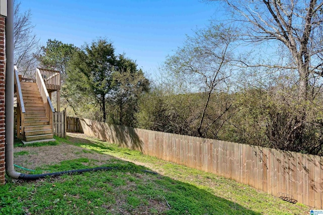 view of yard featuring stairs and fence