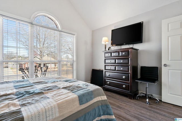 bedroom featuring lofted ceiling, dark wood-style floors, and baseboards