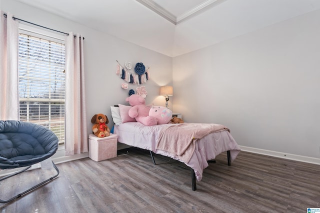 bedroom with ornamental molding, multiple windows, wood finished floors, and baseboards