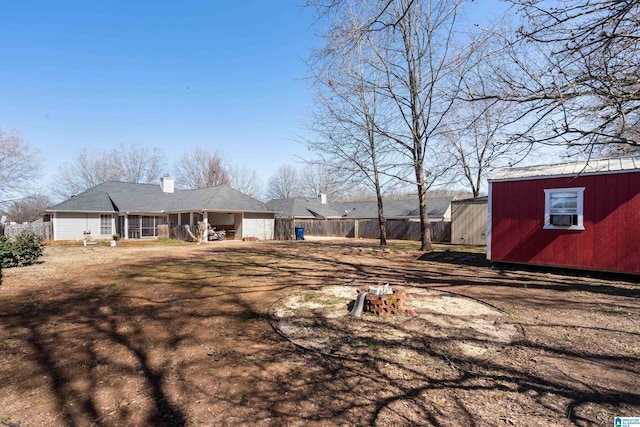 view of yard with an outbuilding, a shed, and fence