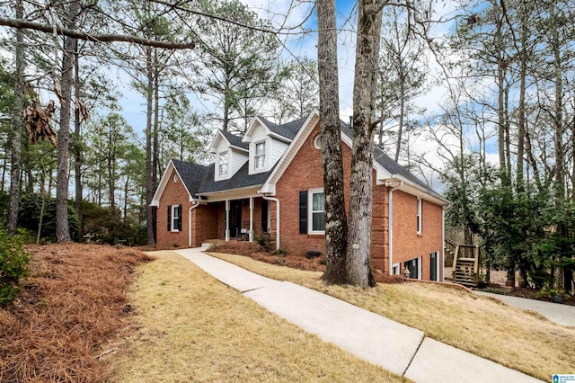 view of front facade featuring a front yard and brick siding