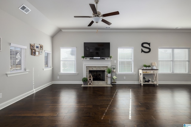 living room with a fireplace, visible vents, and a healthy amount of sunlight