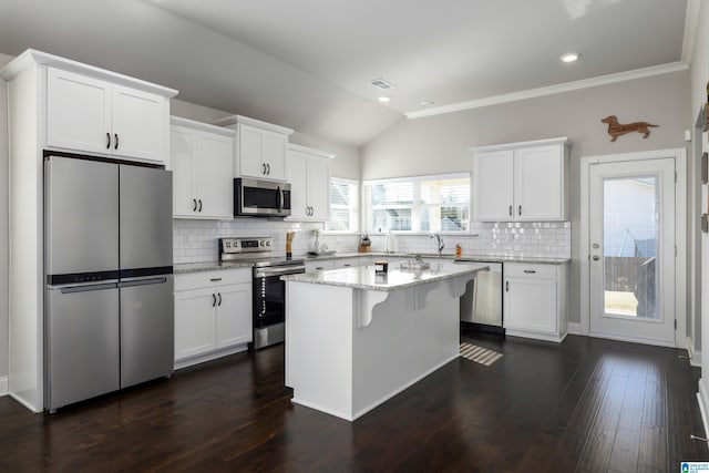 kitchen featuring light stone counters, visible vents, appliances with stainless steel finishes, dark wood-type flooring, and white cabinetry