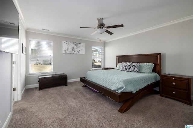 carpeted bedroom featuring ceiling fan, visible vents, baseboards, and crown molding