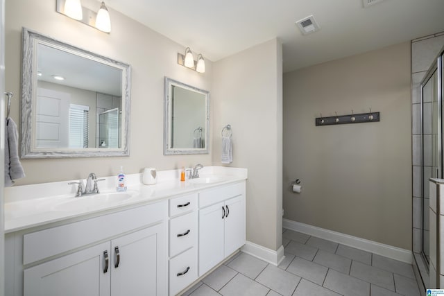 full bathroom with double vanity, tile patterned flooring, a sink, and visible vents