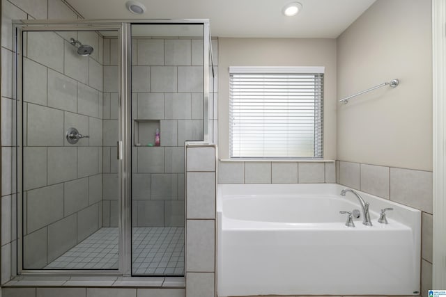 full bathroom with a stall shower and a garden tub