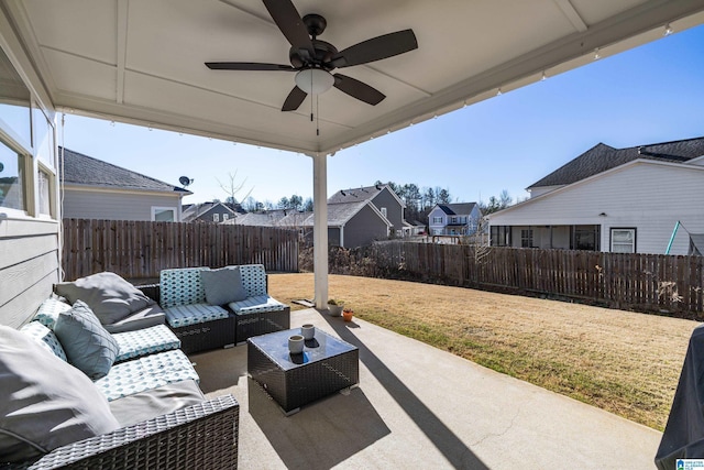 view of patio with a ceiling fan, a residential view, a fenced backyard, and outdoor lounge area