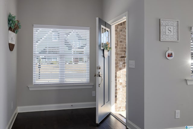 foyer with wood finished floors and baseboards