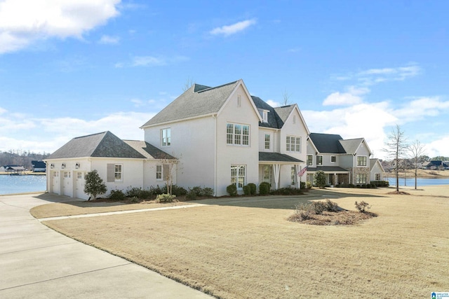 view of side of property with concrete driveway and a water view